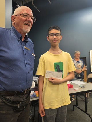 Casper Receiving a Donation from the club for his trip to Italy